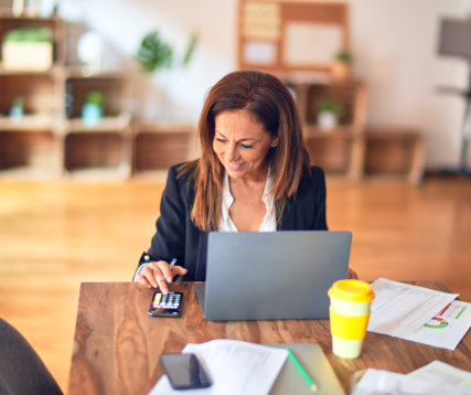 Woman pressing calculator