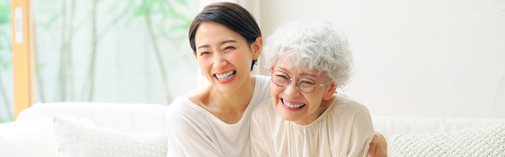 Elder woman and her daughter are smiling