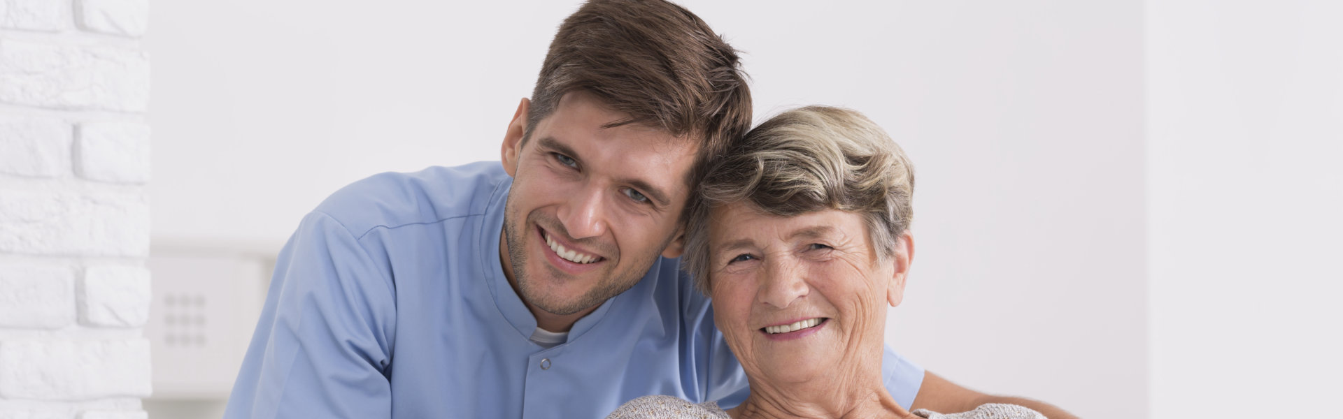 Male nurse and elder woman smiling