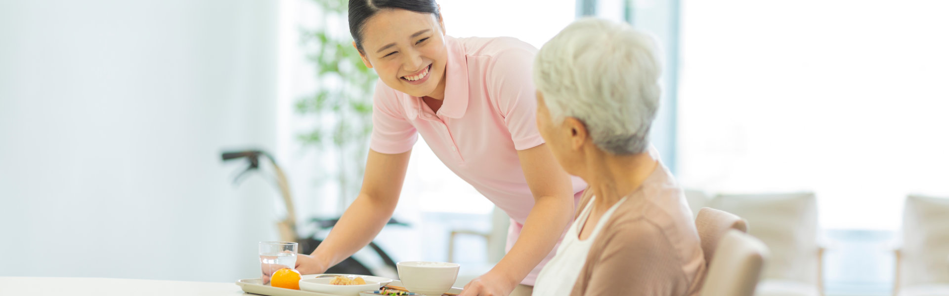 Happy Female caregiver served a food